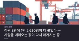 Silhouettes of factory workers in hard hats walking past stacked shipping containers at a port, with a passport and an ink stamp on a desk in the foreground.